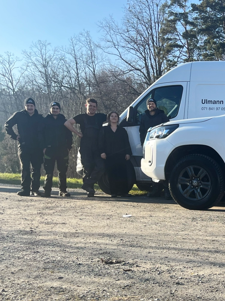 Bild eines Massey Ferguson MF-5X Traktors, der auf einem Feld steht, umgeben von grüner Landschaft.